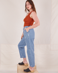 Side view of Denim Trouser Jeans in Light Wash and burnt orange Tank Top worn by Allison