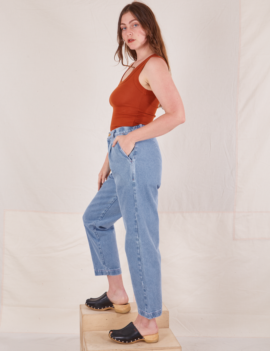 Side view of Denim Trouser Jeans in Light Wash and burnt orange Tank Top worn by Allison