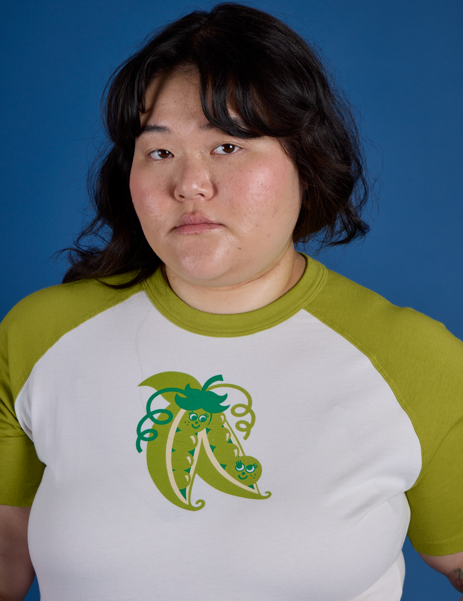Front close up of Produce Raglan Tee in Snap Peas on Ashley