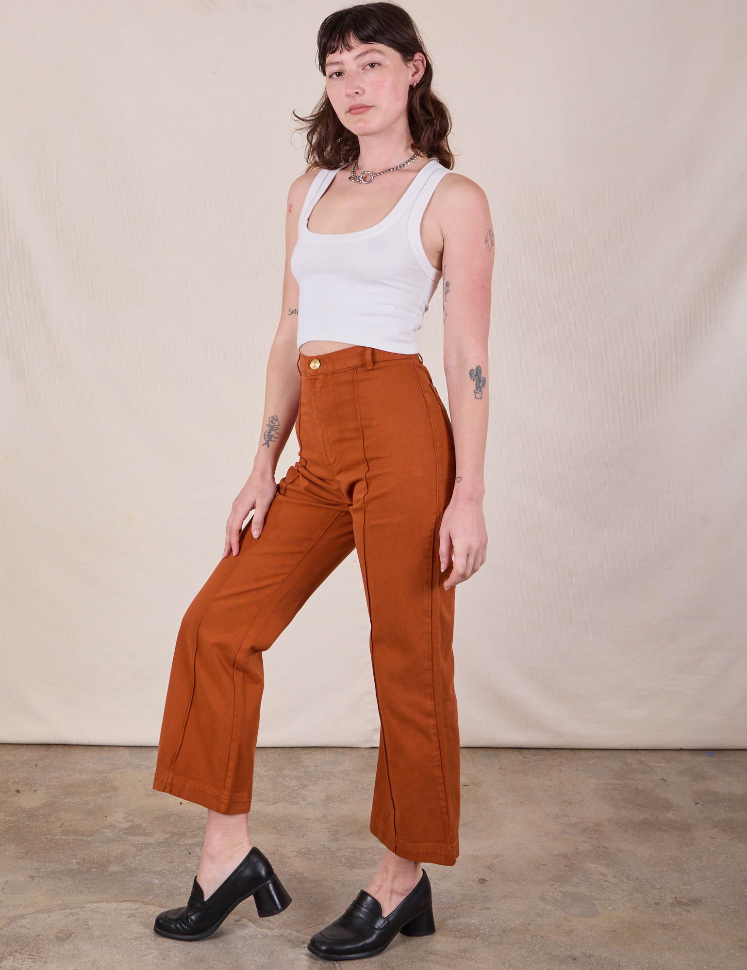 Side view of Western Pants in Burnt Terracotta and Cropped Tank in Vintage Tee Off-White worn by Alex