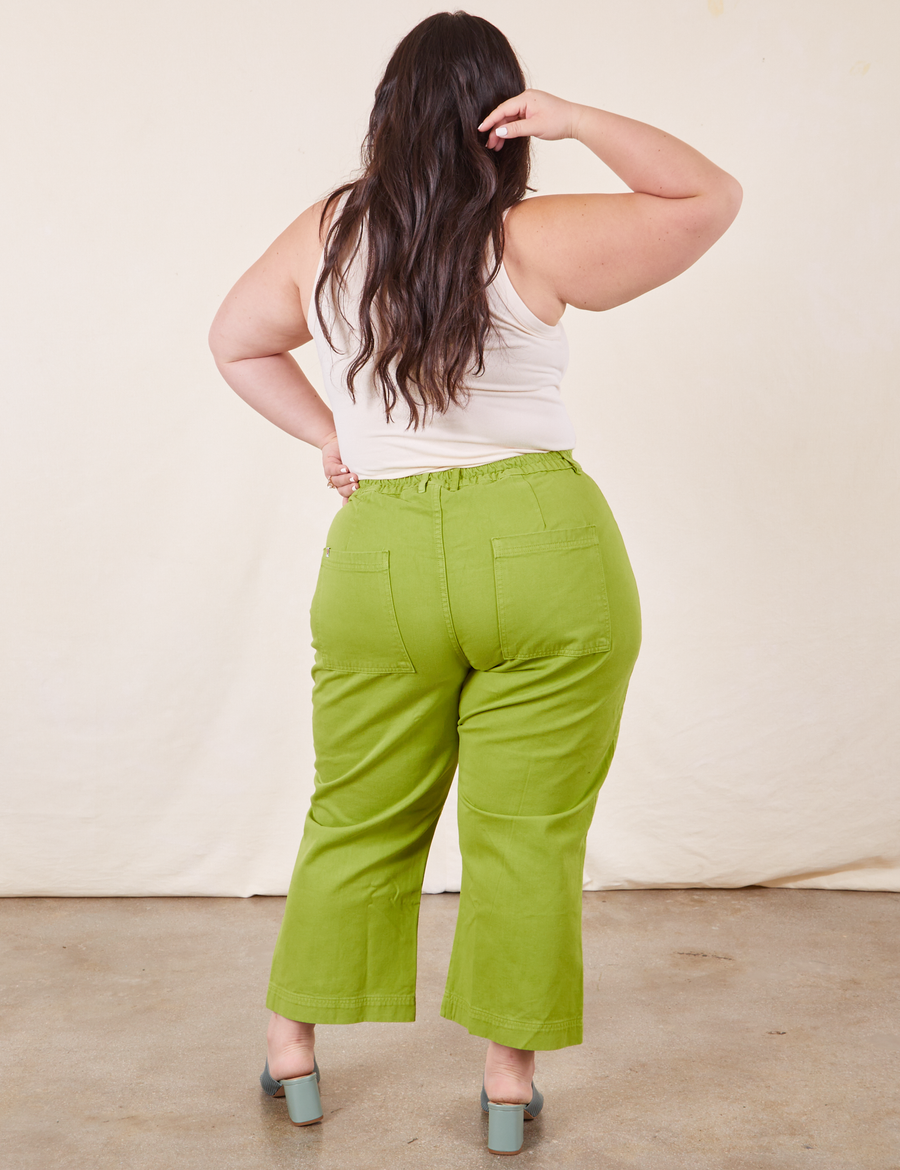 Back view of Western Pants in Gross Green paired with vintage off-white Tank Top worn by Ashley