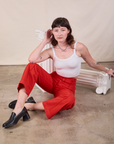 Alex is wearing Western Pants in Mustang Red and Cropped Cami in Vintage Tee Off-White