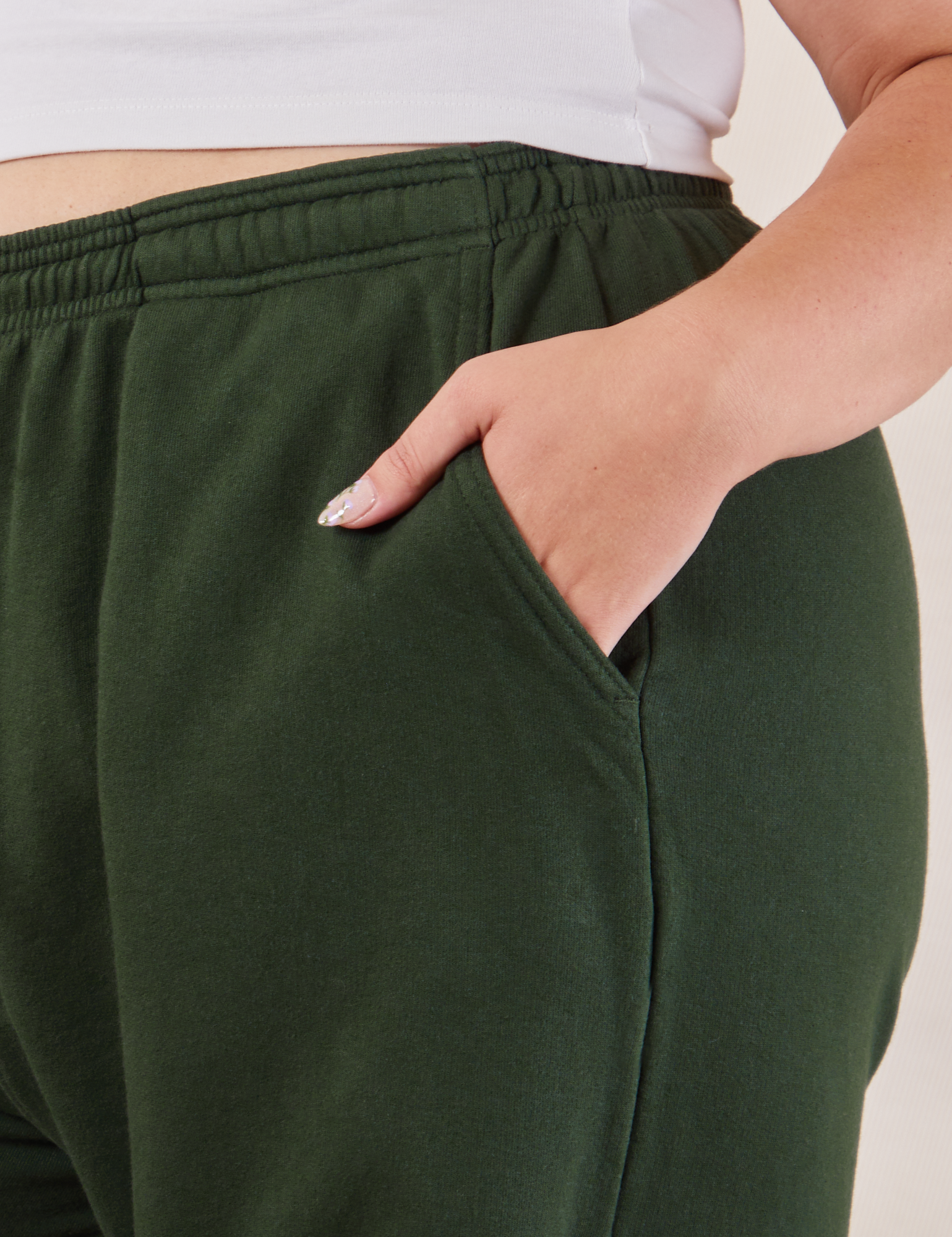 Wide Leg Sweat Pants in Swamp Green side close up with Ryan&#39;s hand in pocket