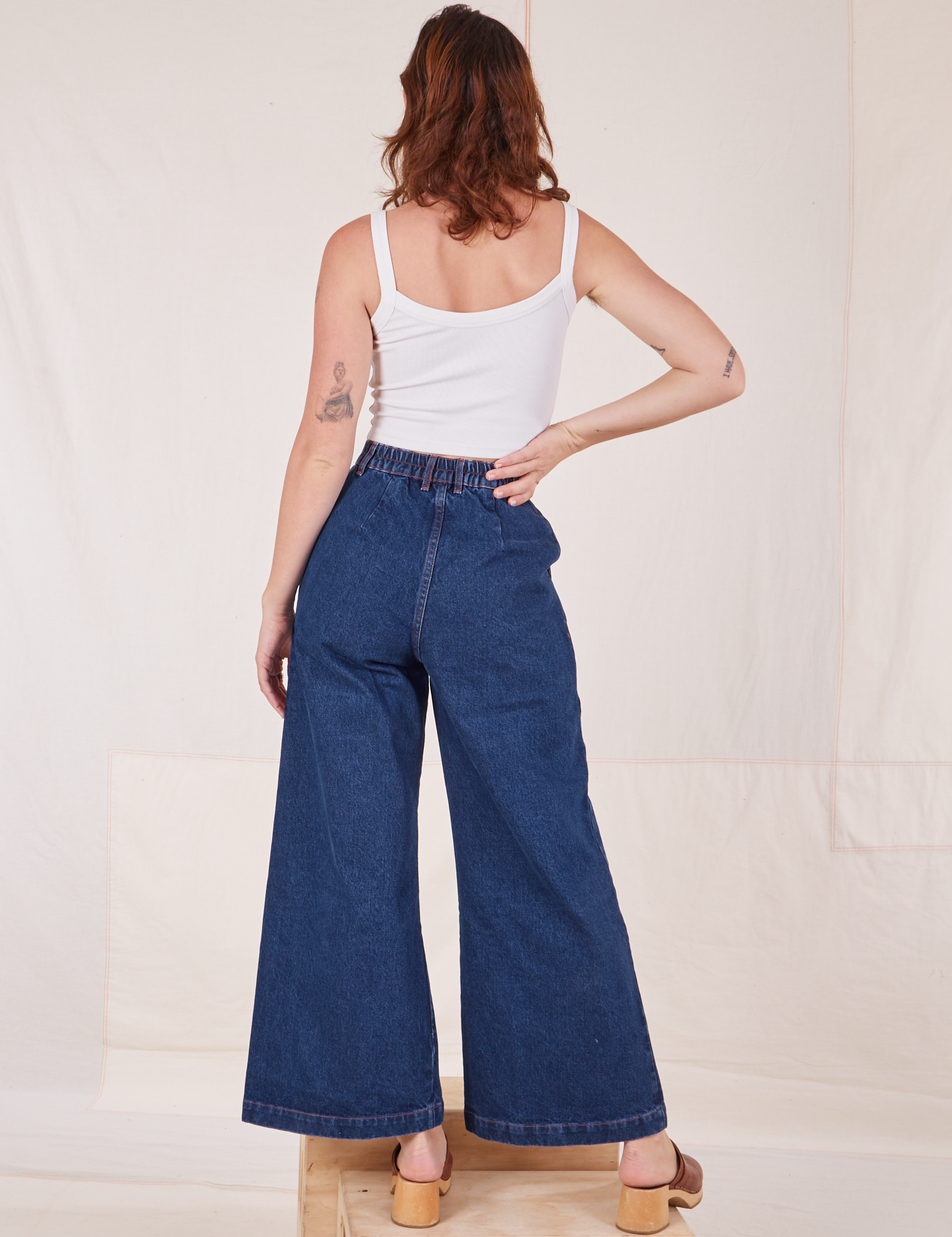 Back view of Indigo Wide Leg Trousers in Dark Wash and vintage off-white Cami