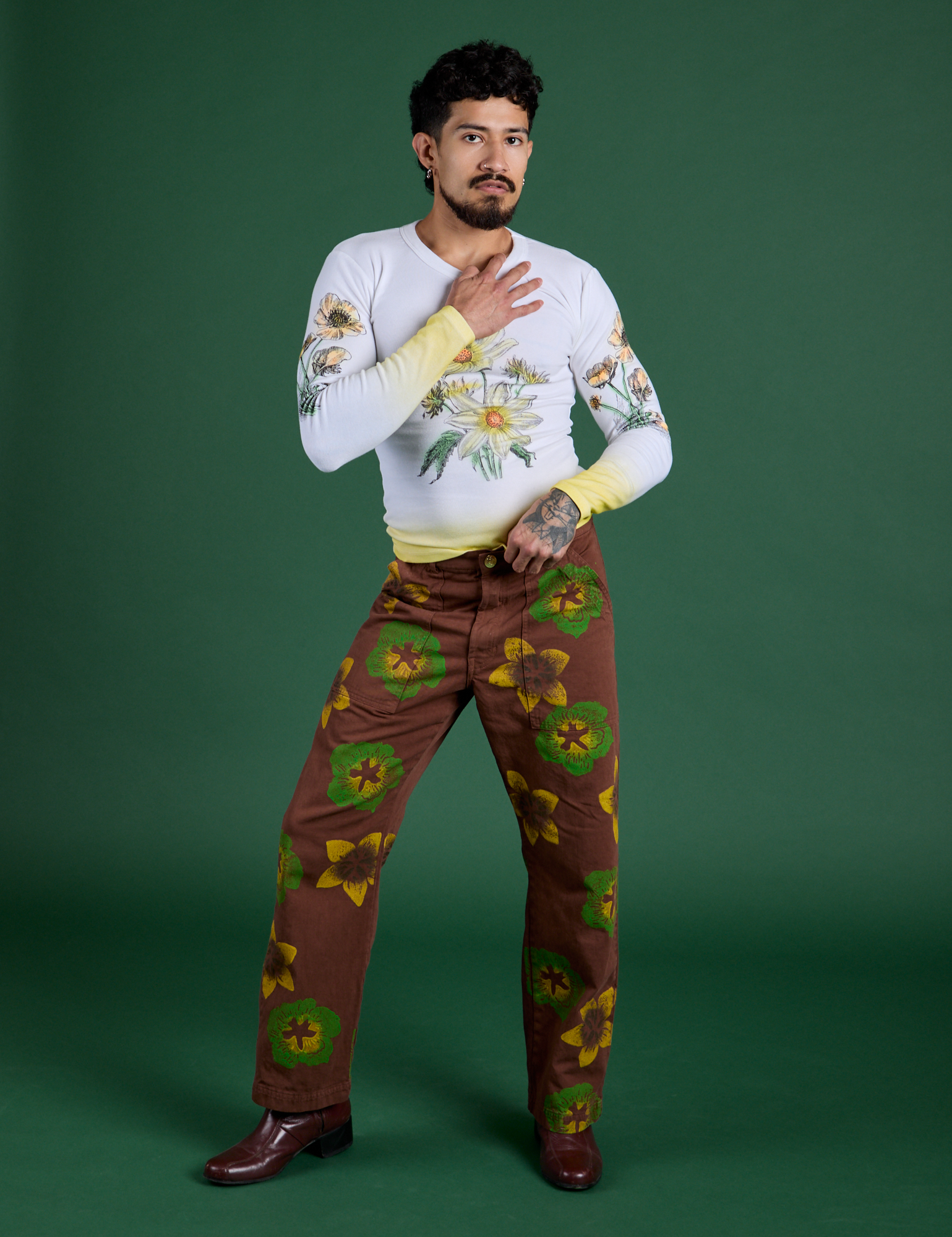 Jesse is wearing Floral Painted Work Pants in Brown and Floral Long Sleeve Baby Tee in Yellow
