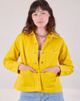 Alex is 5'8" and wearing P Denim Work Jacket in Golden Yellow