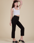 Angled front view of Work Pants in Basic Black and Cropped Tank in Vintage Tee White on Alex