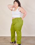 Angled front view of Work Pants in Gross Green and Cropped Tank in vintage tee off-white on Ashley