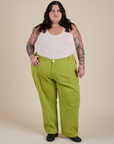 Sam is 5’10” and wearing 4XL Work Pants in Gross Green paired with a vintage tee white Cropped Tank
