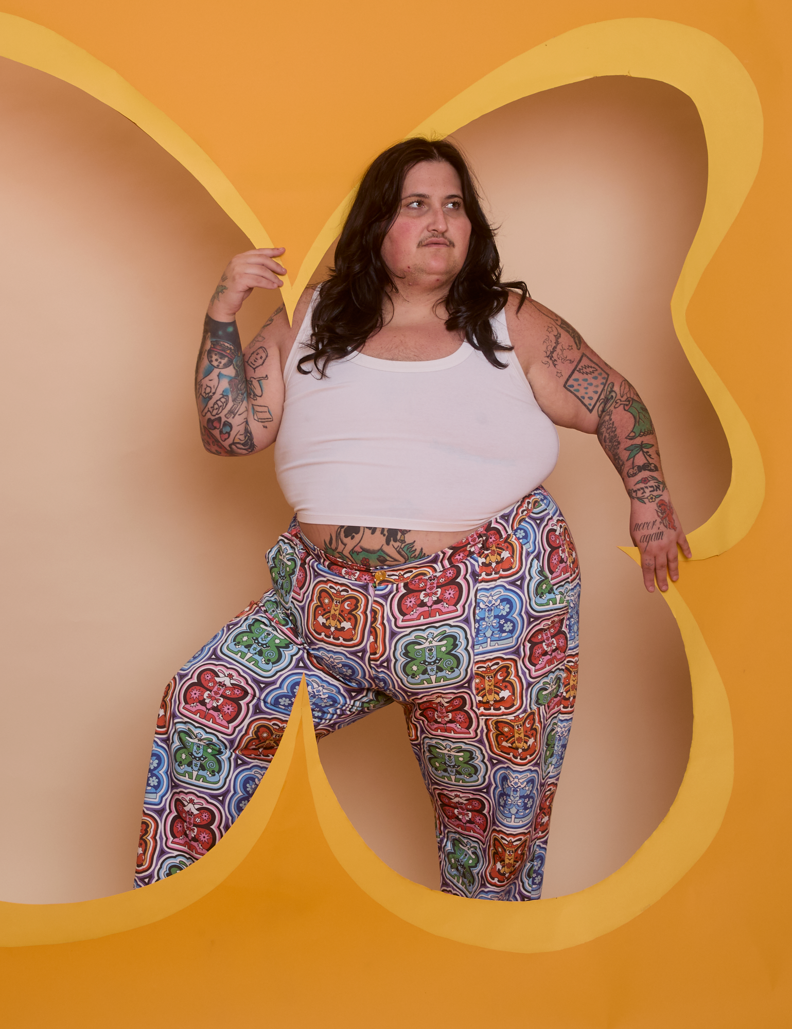 Sam is wearing Butterfly Kaleidoscope Work Pants and Cropped Tank in Vintage Tee White