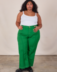 Morgan is 5'5" and wearing 2XL Western Pants in Forest Green paired with a Cropped Cami in Vintage Tee Off-White