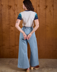 Back view of Calypso Tee in Ocean and light wash Indigo Wide Leg Trousers on Alex