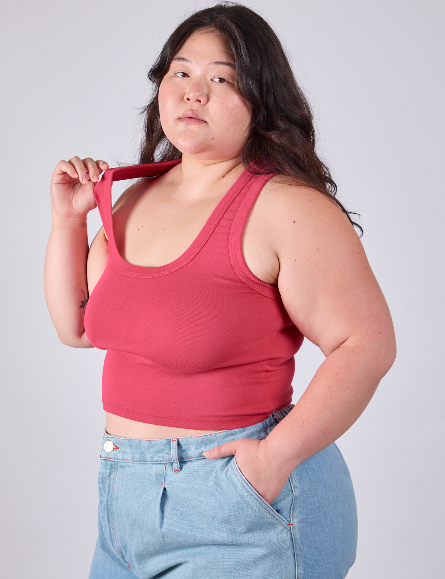 Cropped Tank Top in Hot Pink on Ashley tugging on one of the straps