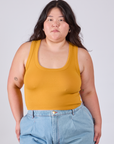 Ashley is 5'7" and wearing L Cropped Tank Top in Mustard Yellow