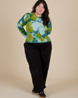 Ashley is wearing Long Sleeve Baby Tee in Green Magic Waters and black Drop Pocket Cargo Pants
