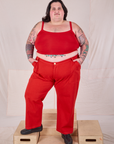 Sam is 5’10” and wearing 4XL Mid-Rise Work Pants in Mustang Red paired with a matching Cropped Cami