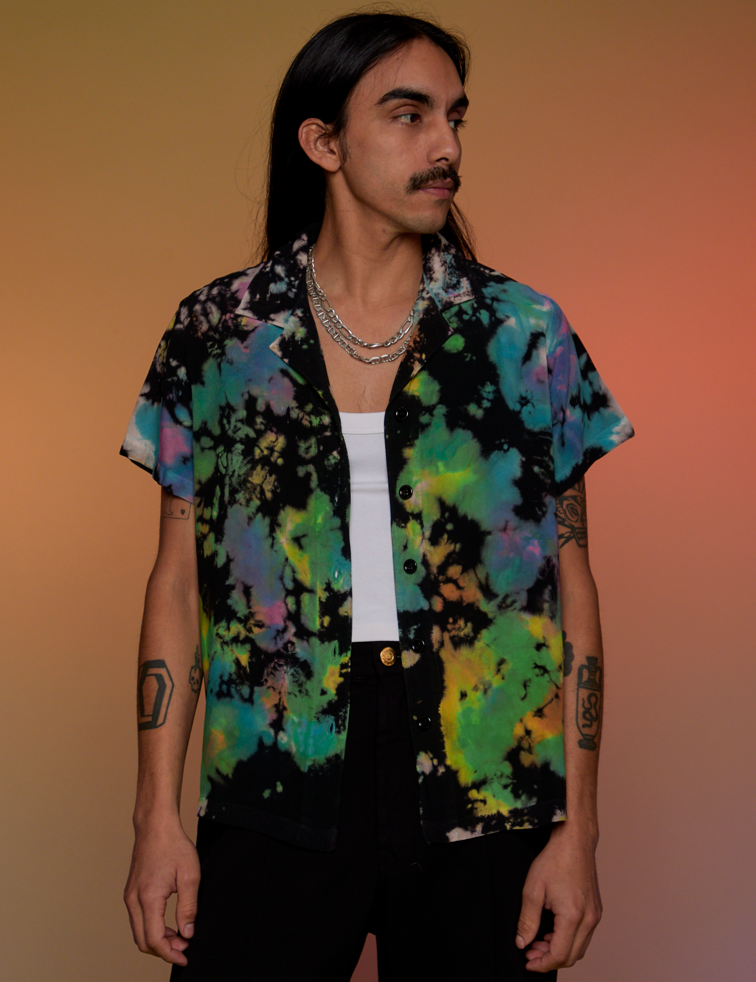 Anthony is 5’6” and wearing S Pantry Button-Up in Rainbow Magic Waters