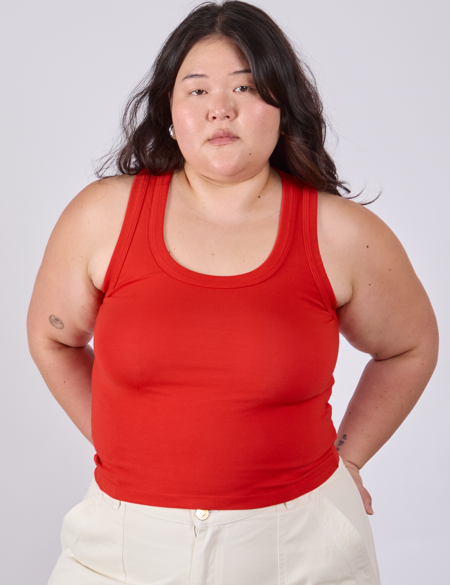 Ashley is 5&#39;7&quot; and wearing L Tank Top in Mustang Red