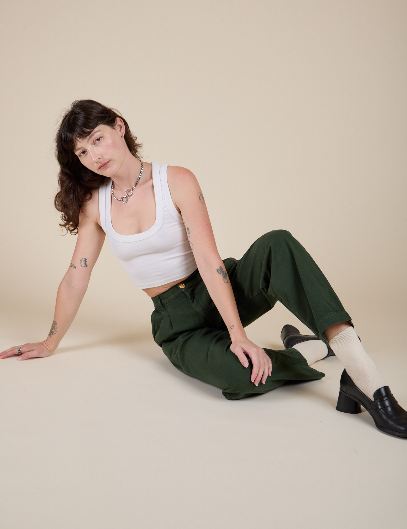 Alex is wearing Heavyweight Trousers in Swamp Green and Cropped Tank in Vintage Tee White