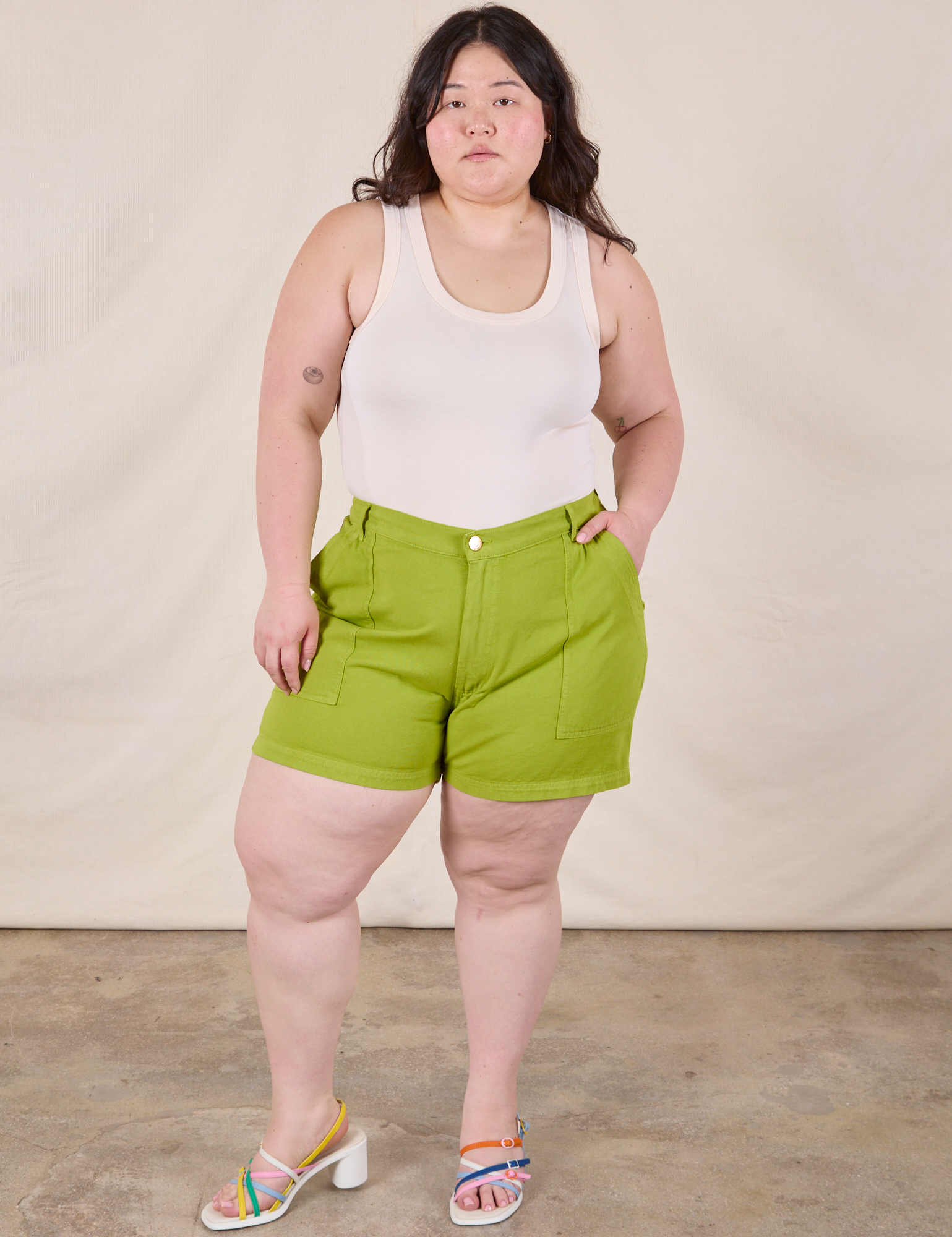 Ashley is wearing Classic Work Shorts in Gross Green and Tank Top in Vintage Tee Off-White