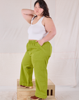 Side view of Action Pants in Gross Green and Cropped Tank in Vintage Tee Off-White on Ashley