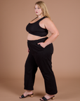 Side view of Action Pants in Basic Black and black Mini Tank on Juliet
