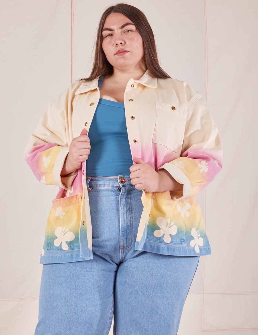 Marielena is 5'8" and wearing 2XL Work Jacket in Butterfly Airbrush with marine blue Cropped Tank underneath