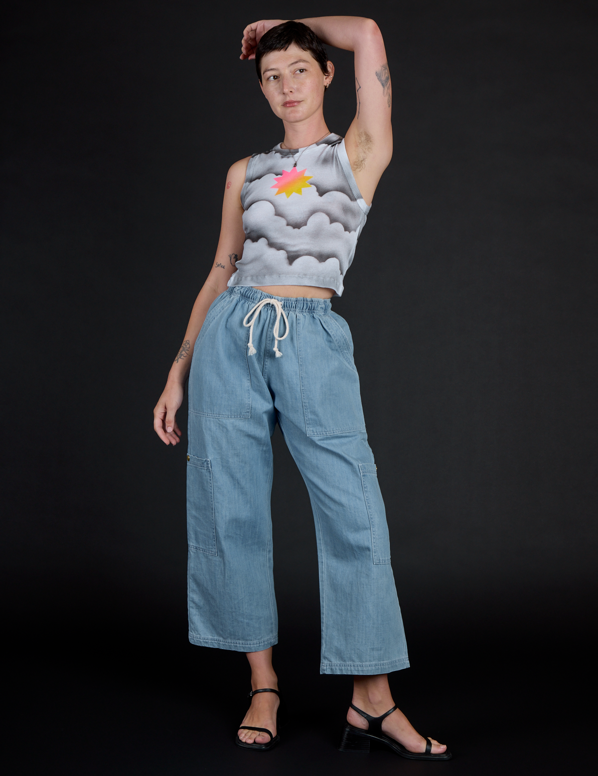 Alex wearing the Dark Cloud Airbrush Muscle Tee with Light Wash Denim Drop Pocket Pants