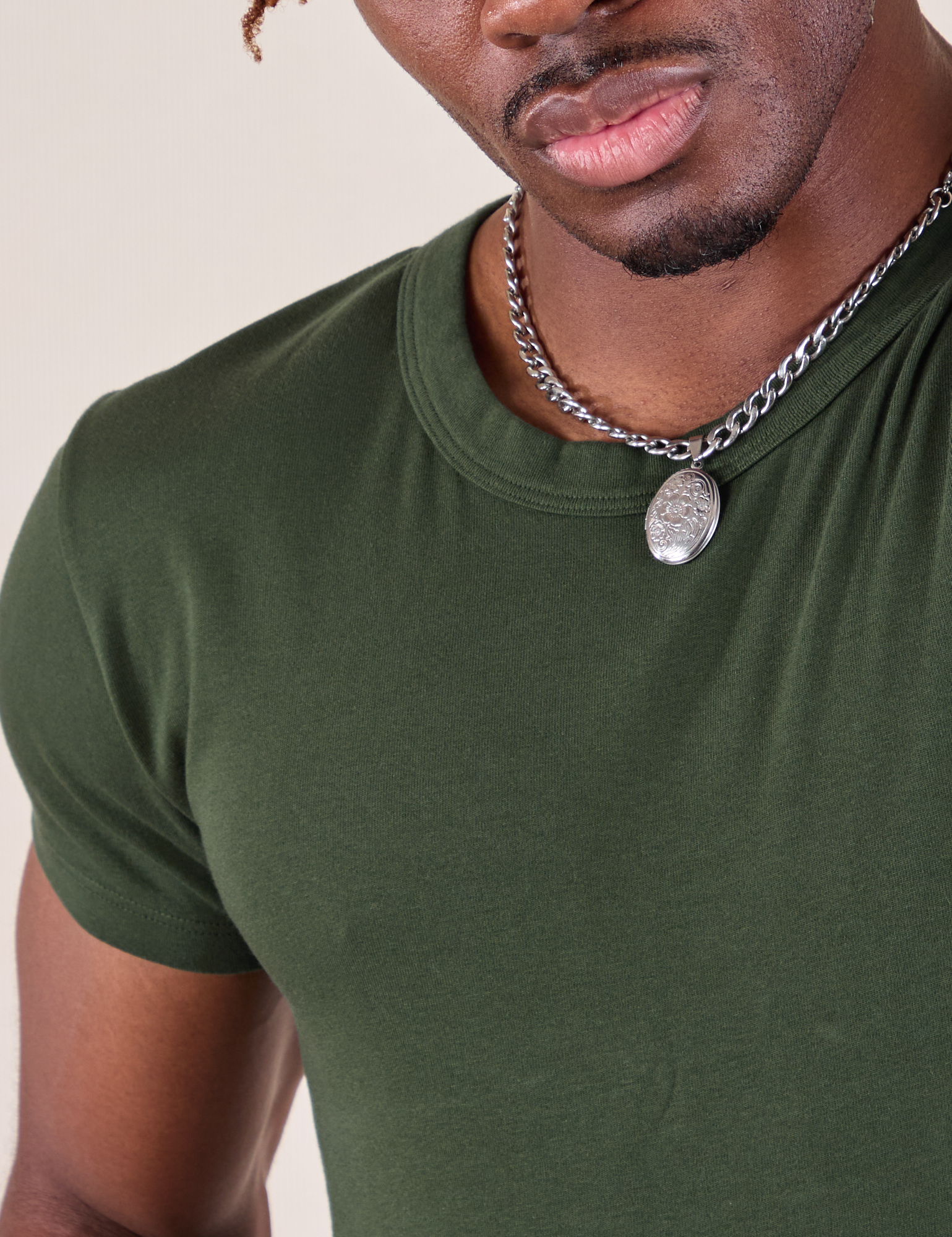 Baby Tee in Swamp Green neckline close up on Isaac