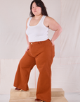 Angled front view of Bell Bottoms in Burnt Terracotta and Cropped Tank in vintage tee off-white on Ashley