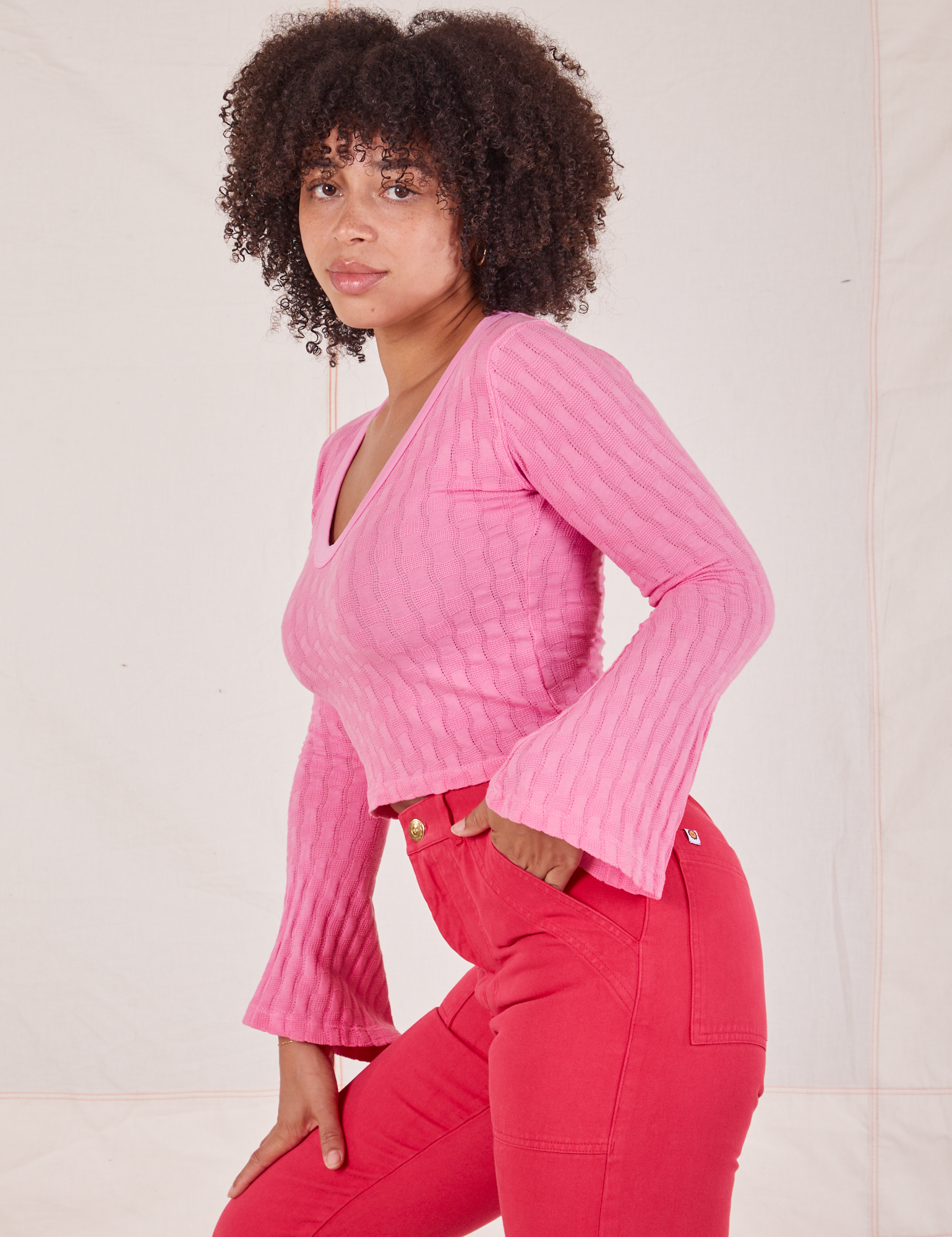 Side view of Bell Sleeve Top in Bubblegum Pink and hot pink Work Pants worn by Gabi