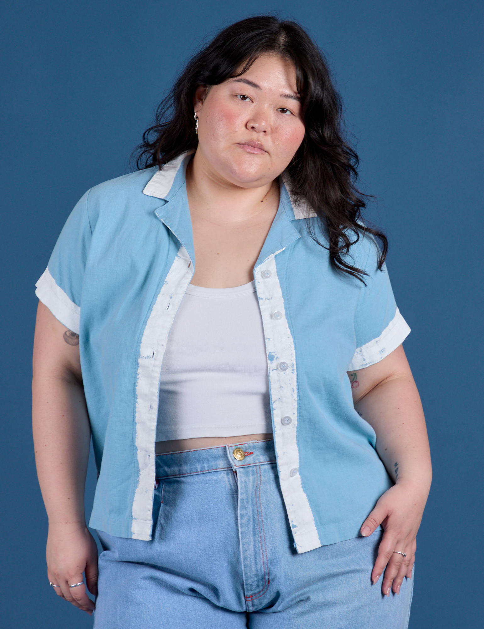 Ashley is 5’7” and wearing L Painted Pantry Button-Up in Baby Blue