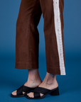 Painted Action Pants in Fudgesicle Brown pant leg close up on Alex