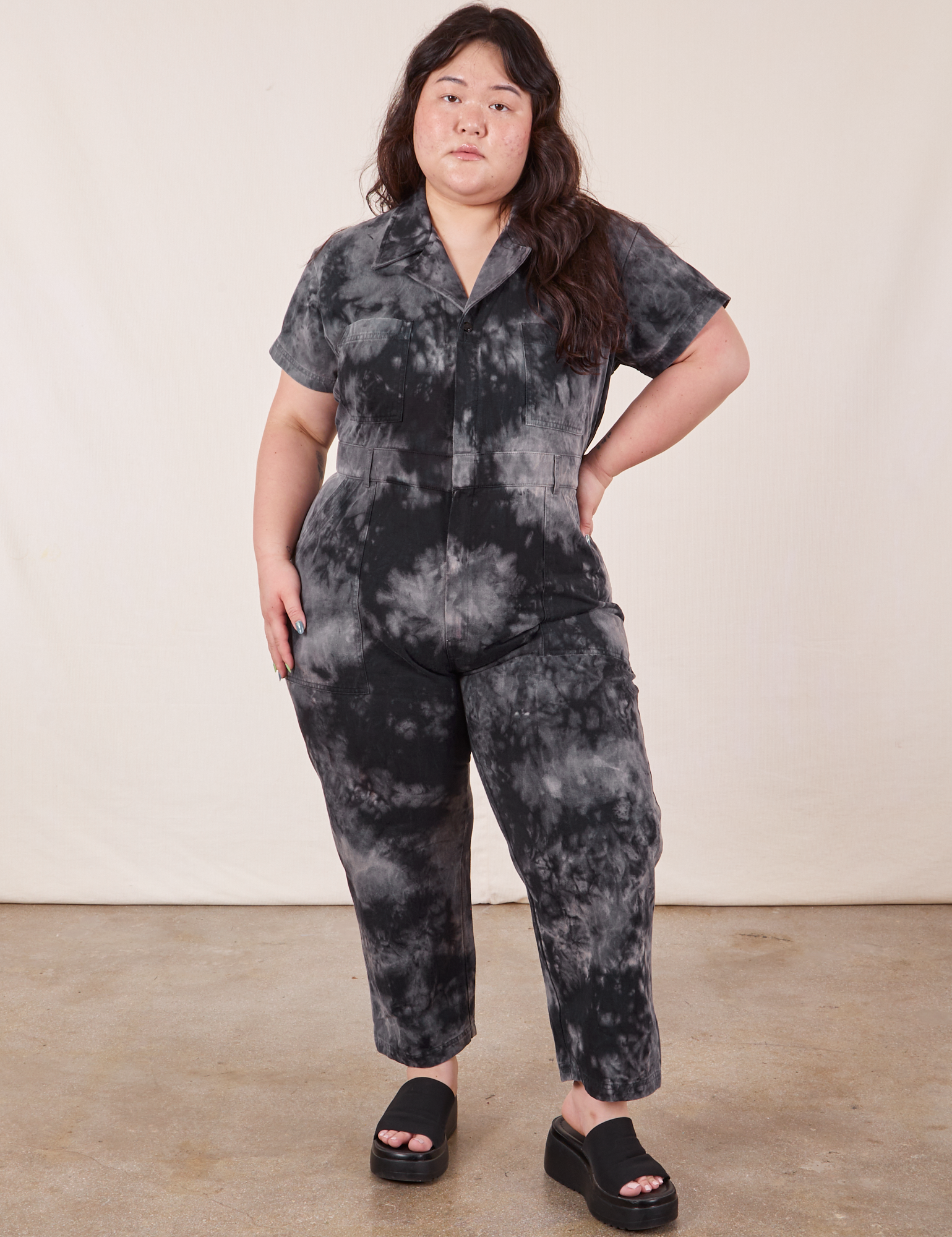 Ashley is 5&#39;7&quot; and wearing 1XL Petite Short Sleeve Jumpsuit in Black Magic Waters