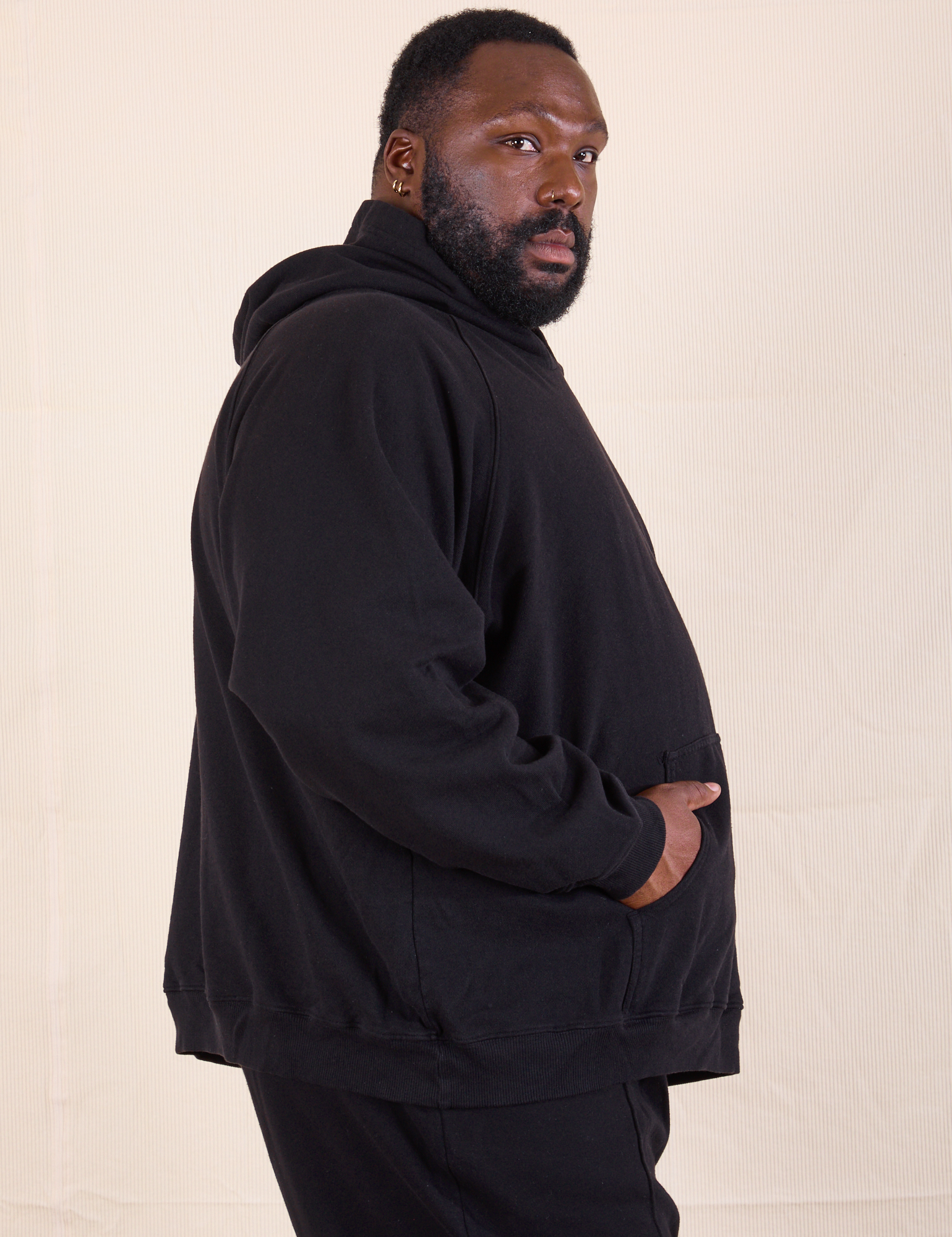 Oversized Hoodie in Basic Black side view on Elijah