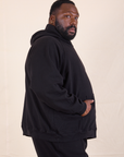 Oversized Hoodie in Basic Black side view on Elijah