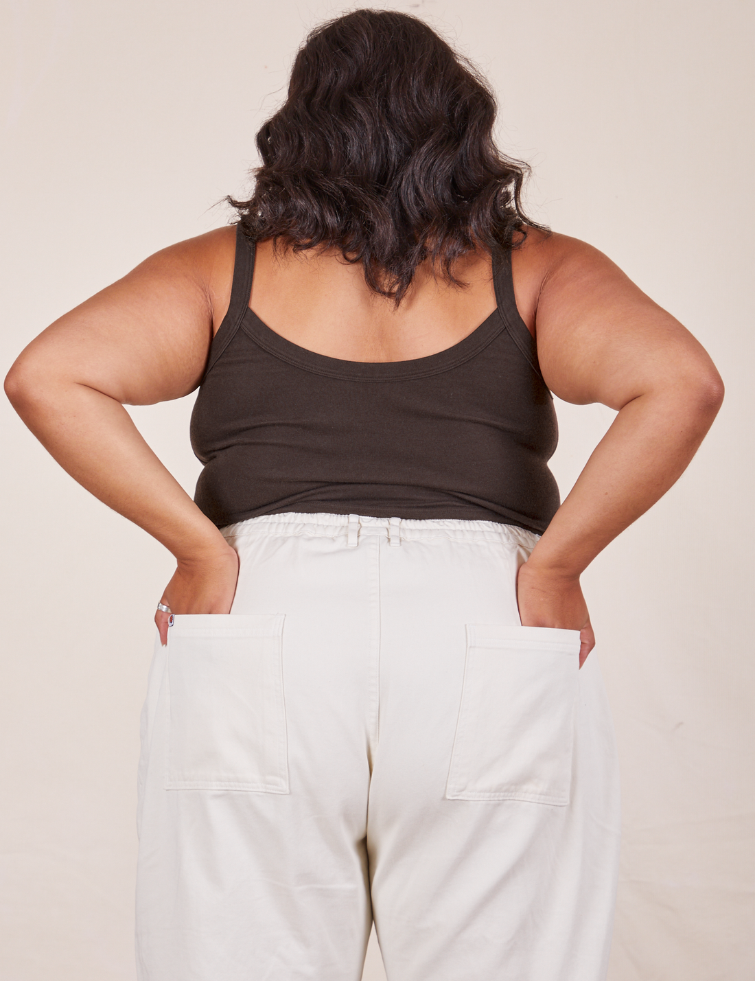 Back view of Cropped Cami in Espresso Brown and vintage off-white Western Pants worn by Alicia. She has both hands in the back pant pockets.