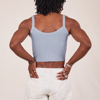Back view of Cropped Cami in Periwinkle and vintage off-white Western Pants worn by Jerrod