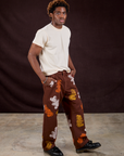 Angled front view of Gummy Bear Paintstamped Work Pants in Fudgesicle Brown and Organic Vintage Tee in Vintage Off-White