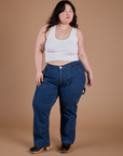 Ashley is 5’7” and wearing 1XL Carpenter Jeans in Dark Wash paired with a Cropped Tank in Vintage Tee White