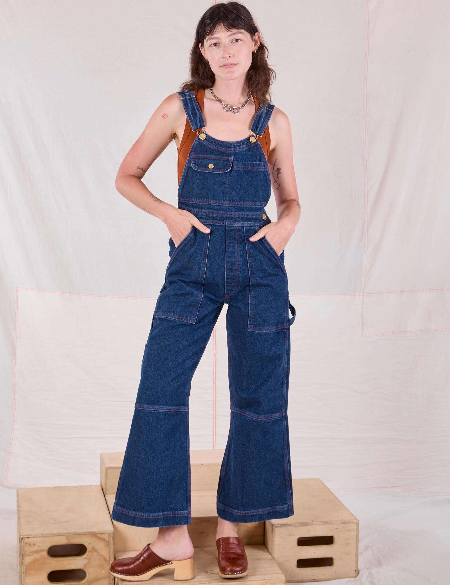 Alex is 5&#39;8&quot; and wearing XXS Carpenter Overalls in Dark Wash