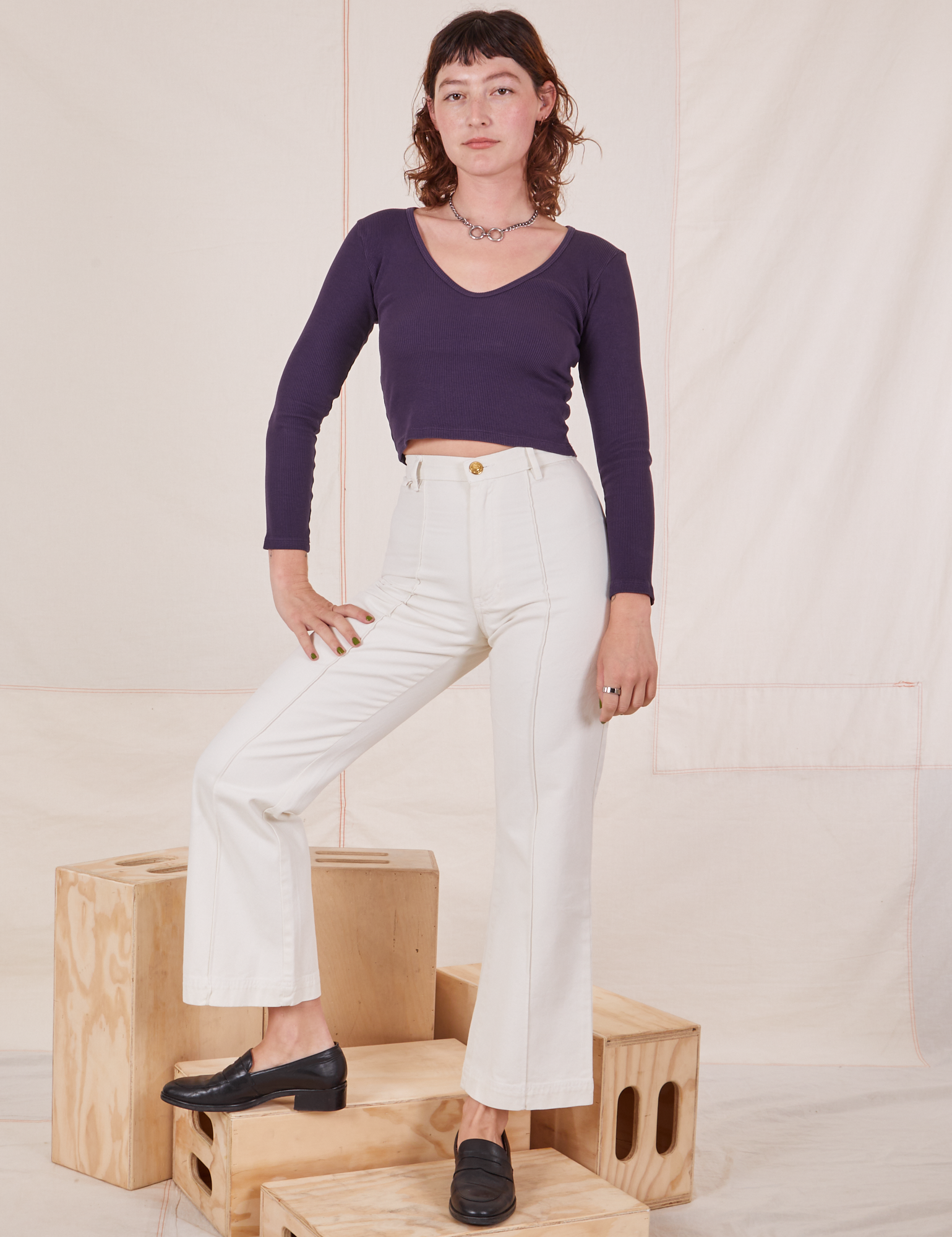 Alex is wearing Long Sleeve V-Neck Tee in Nebula Purple and vintage off-white Western Pants