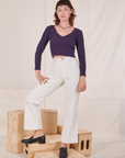 Alex is wearing Long Sleeve V-Neck Tee in Nebula Purple and vintage off-white Western Pants