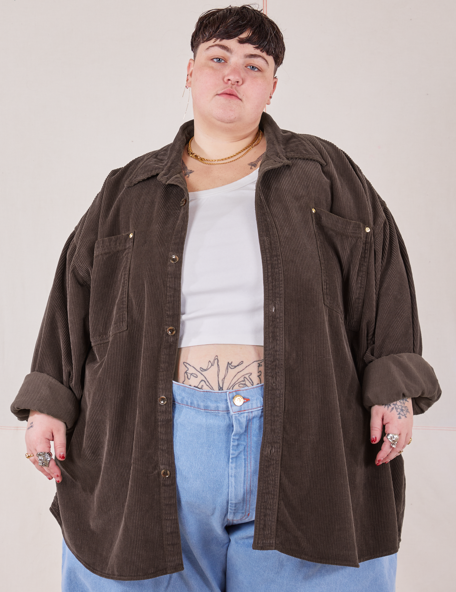 Jordan is 5&#39;4&quot; and wearing 4XL Corduroy Overshirt in Espresso Brown with a vintage off-white Cropped Tank Top underneath paired with light wash Denim Trouser Jeans