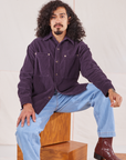 Jesse is wearing Corduroy Overshirt in Nebula Purple and light wash Denim Trouser Jeans