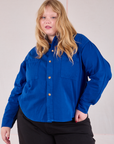 Juliet is wearing a buttoned up Cropped Overshirt in Royal Blue