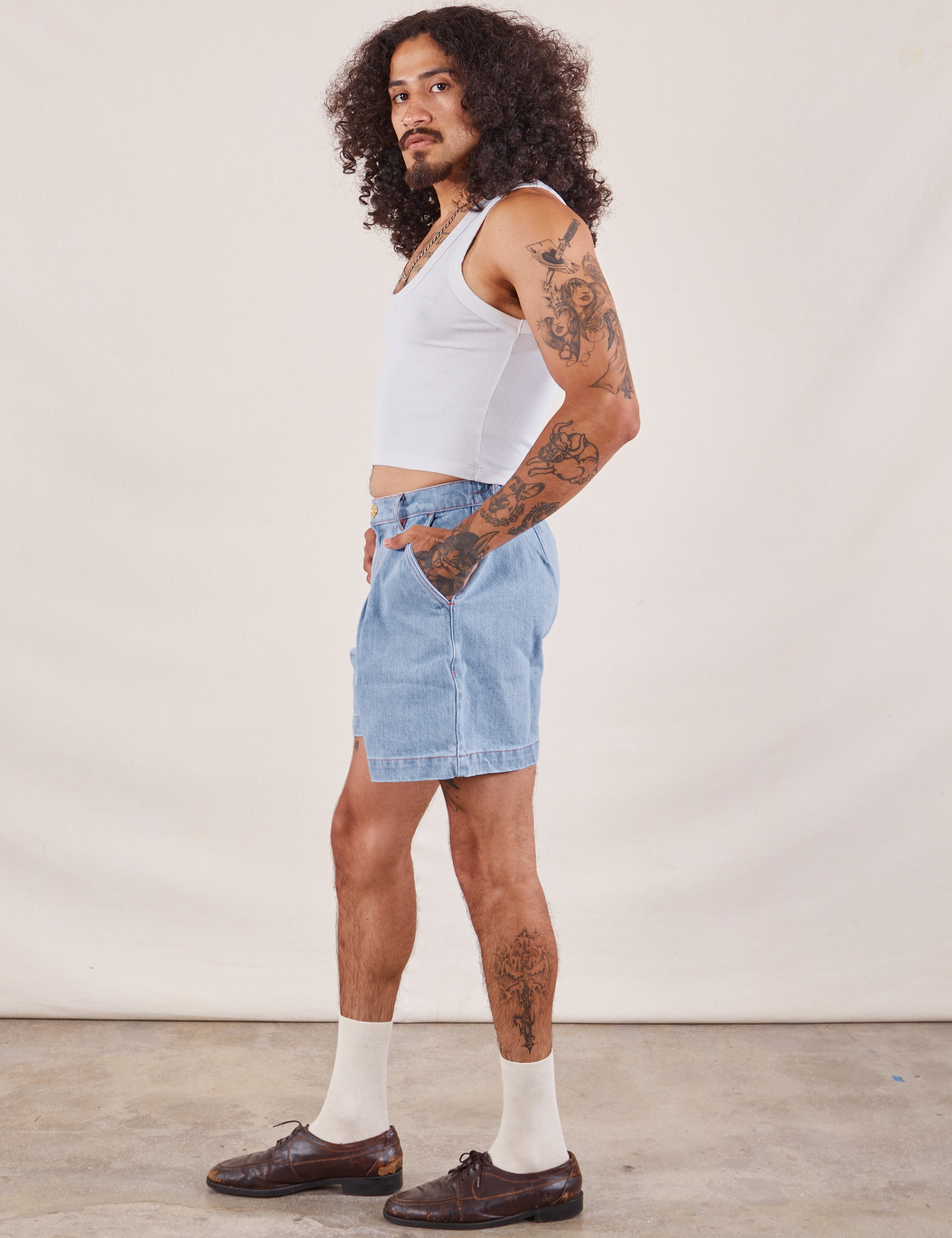 Side view of Denim Trouser Shorts in Light Wash and Cropped Tank in vintage tee off-white