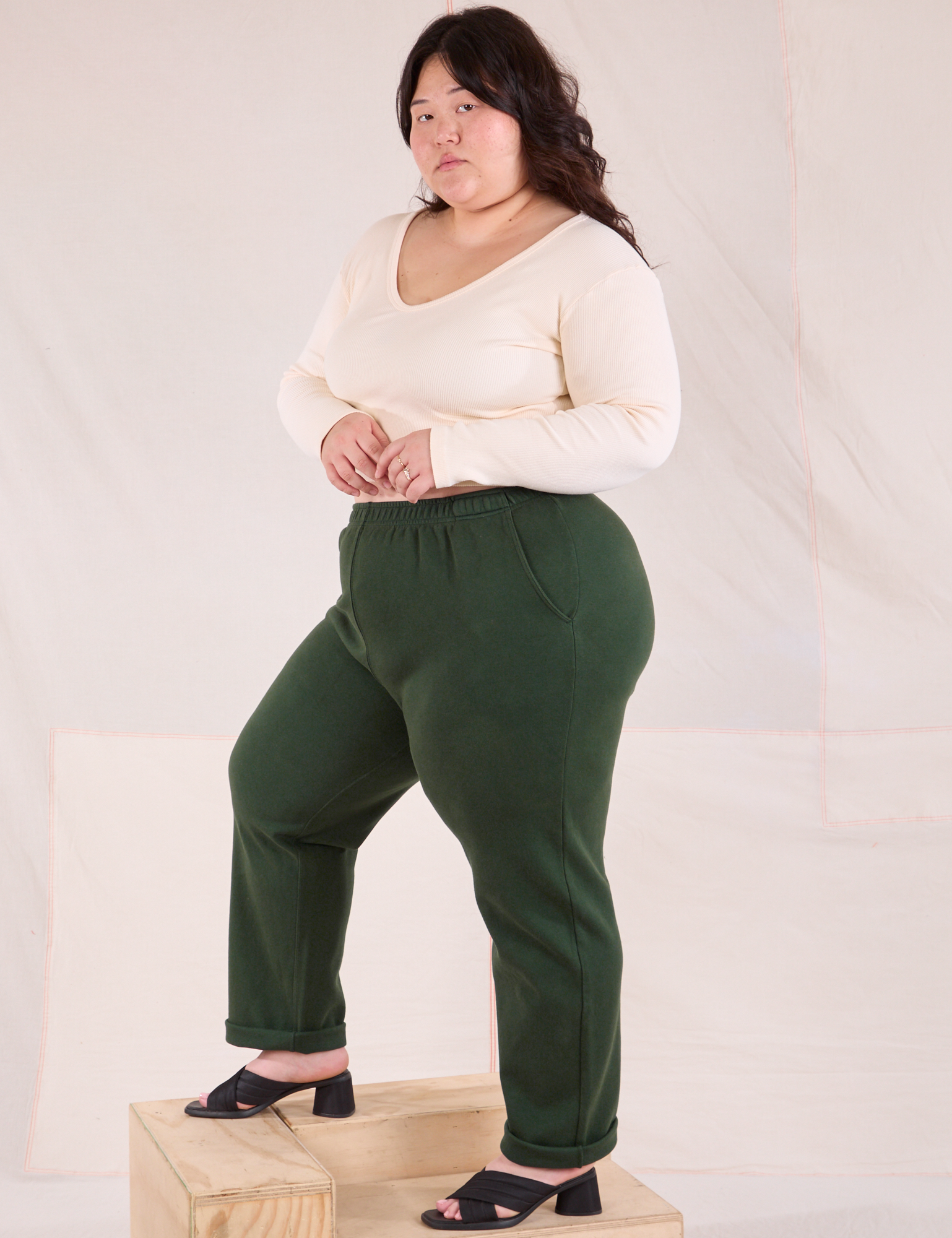 Side view of Easy Pants in Swamp Green and Long Sleeve V-Neck in vintage tee off-white