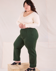 Side view of Easy Pants in Swamp Green and Long Sleeve V-Neck in vintage tee off-white