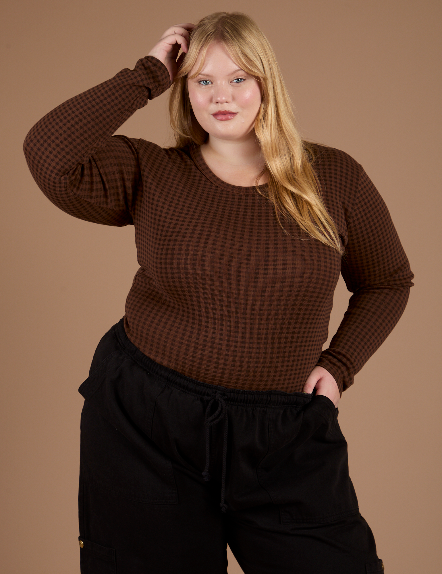 Juliet is wearing Long Sleeve Baby Tee in Fudgesicle Brown